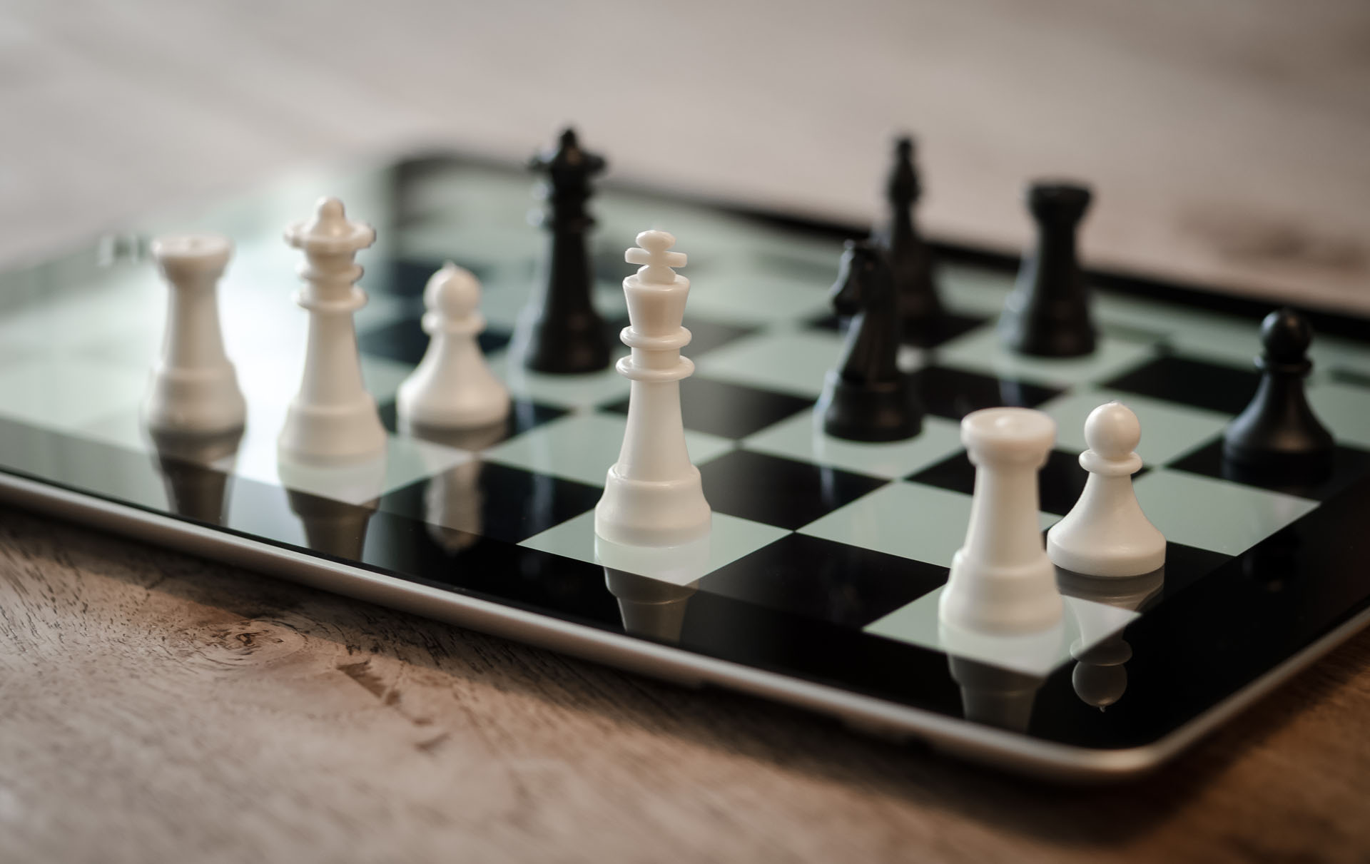 Photo of black and white chess pieces on a chess board.